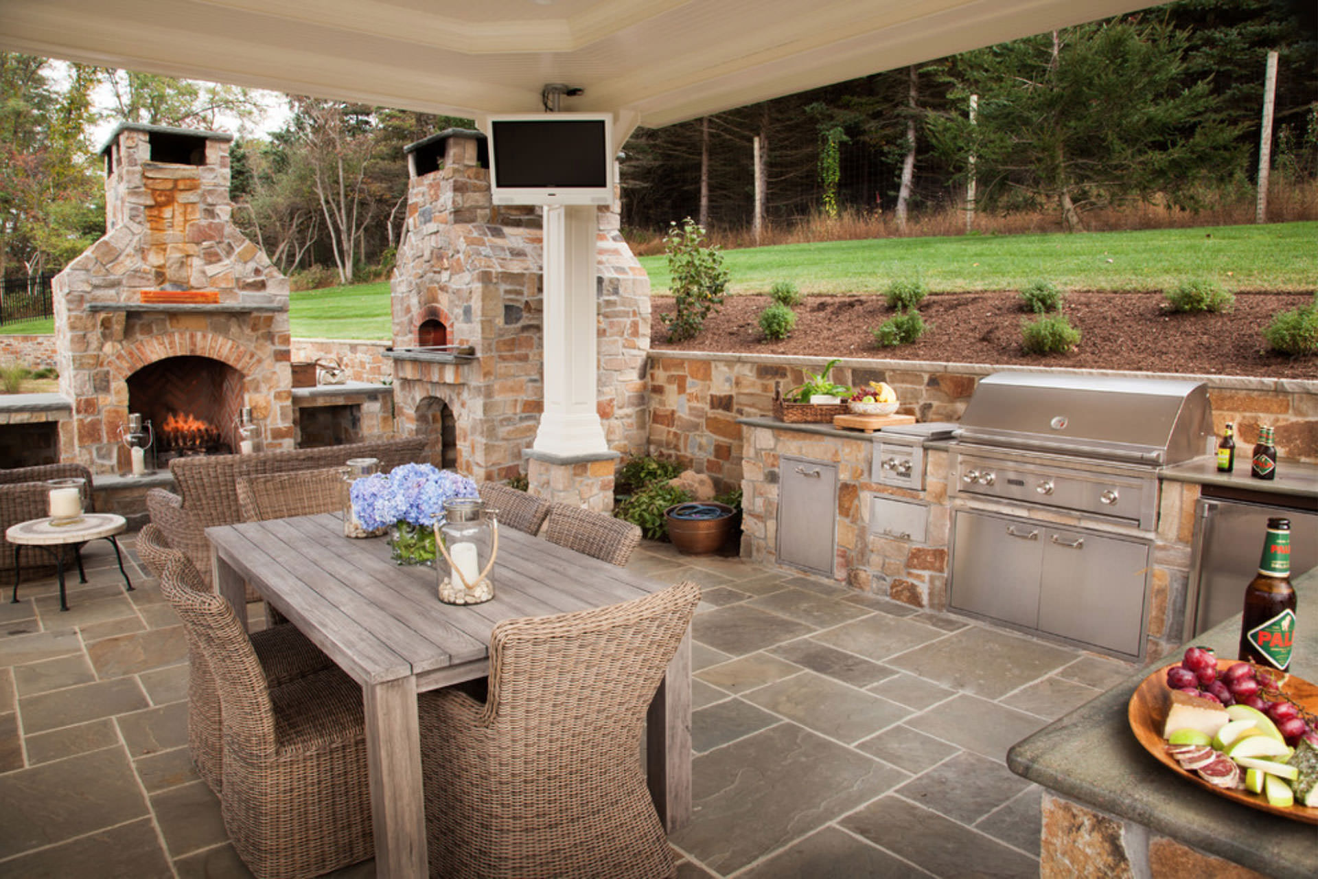 outdoor coverd space for table outdoor kitchen and fireplace